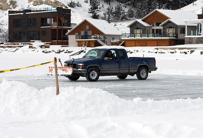 A plow clears snow off of Lake Windermere after an overnight dump on Sunday