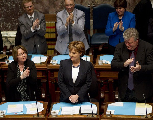 Premier Christy Clark is applauded by fellow MLAs as she takes her seat in the legislature Monday.