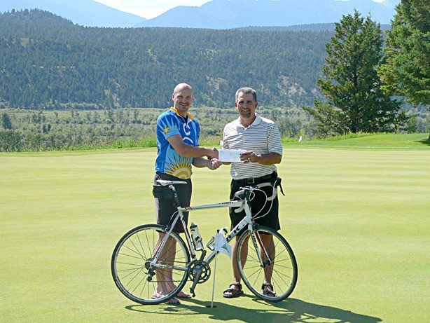 Shane Wiens accepts a cheque from Bob Powers