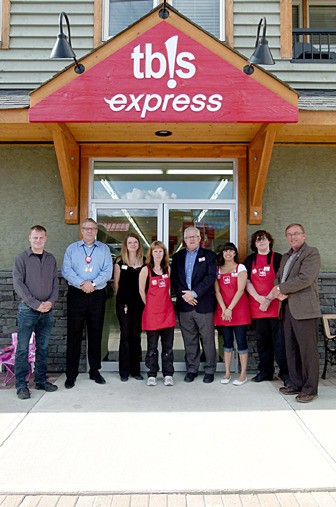 T: Staff and representatives of the District and tb!s are all smiles at the new tb!s express on 13th Street in Invermere opens its doors.