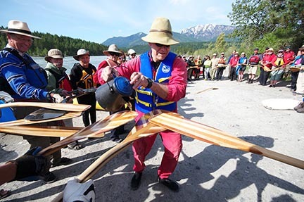 The 2011 David Thompson Columbia brigade ceremoniously anoints their paddles before launching into the Kootenay River at Canal Flats.