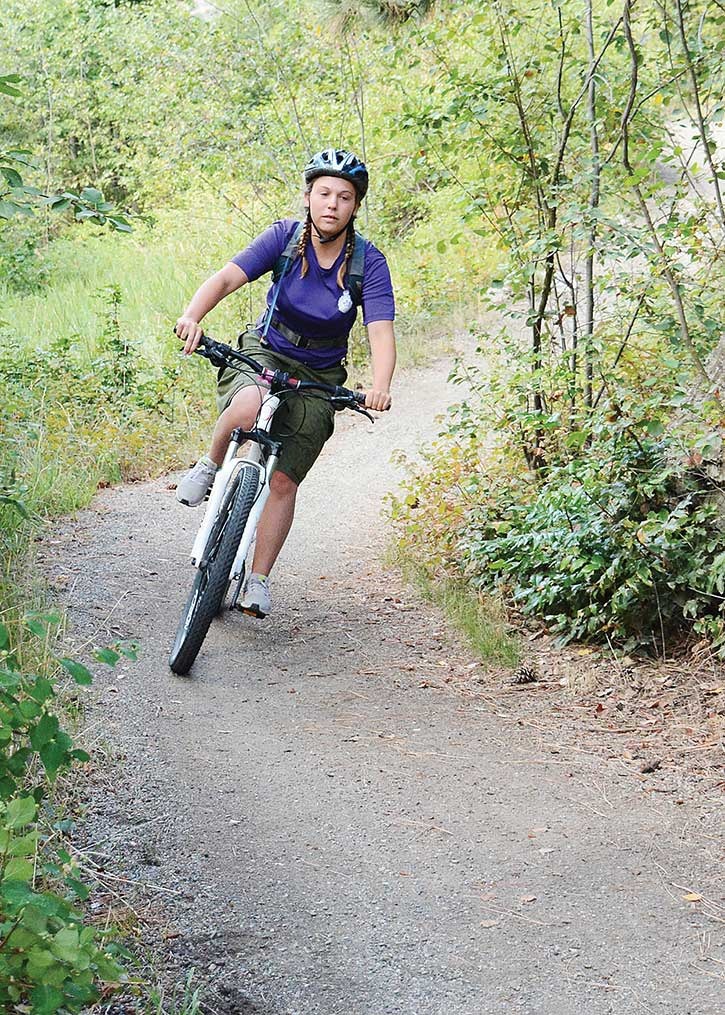 Cadet Tyonna Tench of Canal Flats eases into a curve while mountain biking in Kalamalka Lake Park near Vernon Cadet Training Centre as part of her Expedition Instructor Course.