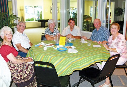 A table party waits for dinner to be served and door prizes to be called.