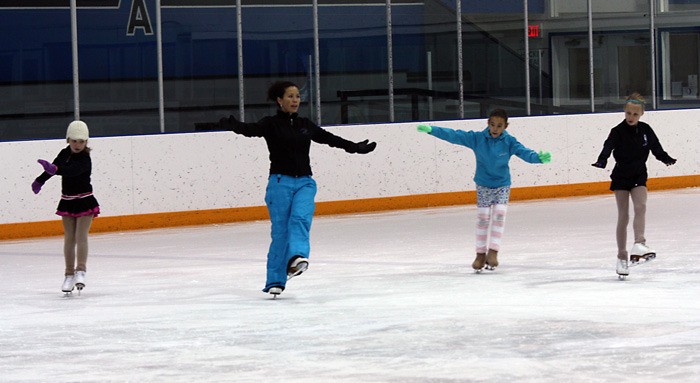 Head coach Daniele Elford leads a group of skaters through exercises during the day-long workshop at Eddie Mountain Memorial Arena. Skaters are (from left) Natasha Barsby