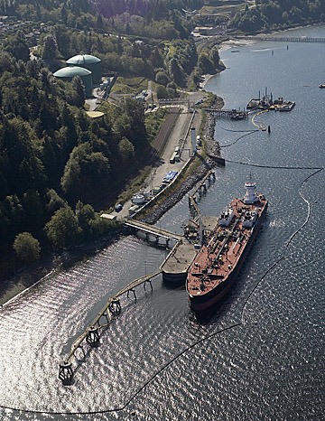 An oil tanker is surrounded by a containment boom as it loads crude oil at Westridge Terminal in Burnaby.