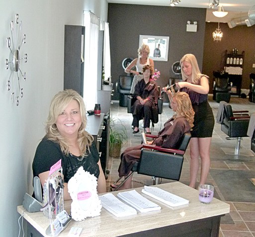 Christine Johansen sits at the front desk of the Scizzor Sisters hair salon