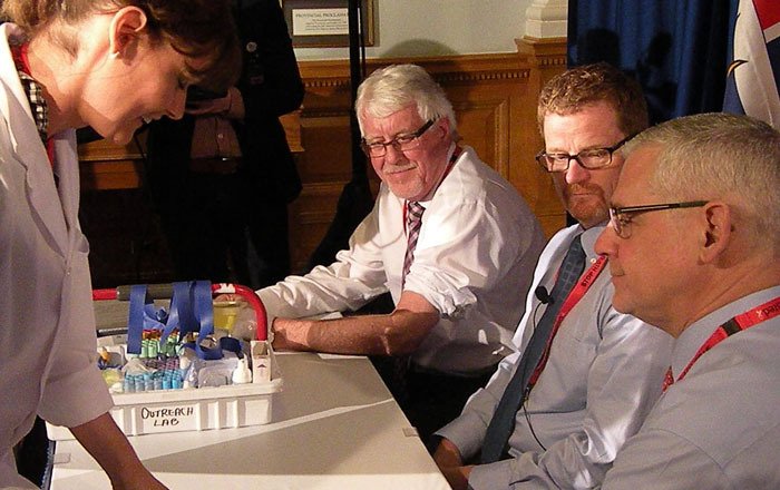 Nurse Claire Madill prepares to take blood samples for HIV testing from Provincial Health Officer Dr. Perry Kendall