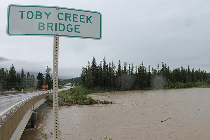 Surging waters at Toby Creek are carrying massive logs down the river.