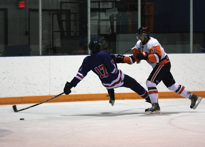 Rockies forward Aaron Barclay lays a big hit on Kamploops Storm defenceman Shane Poulsen during the second period of the Rockies home loss.