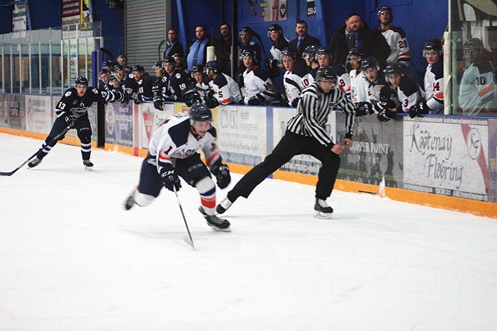 Rockies forward Donoven Quintin skates past his home bench while chasing the puck in the third of four playoff games against the Creston Thunder Cats on Friday