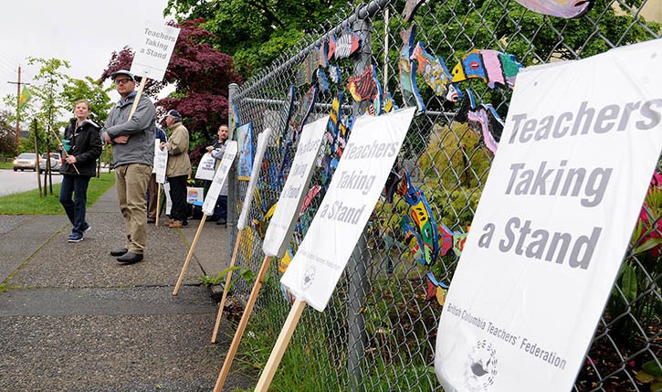 Teachers at Tweedsmuir elementary school man their picket line on Monday