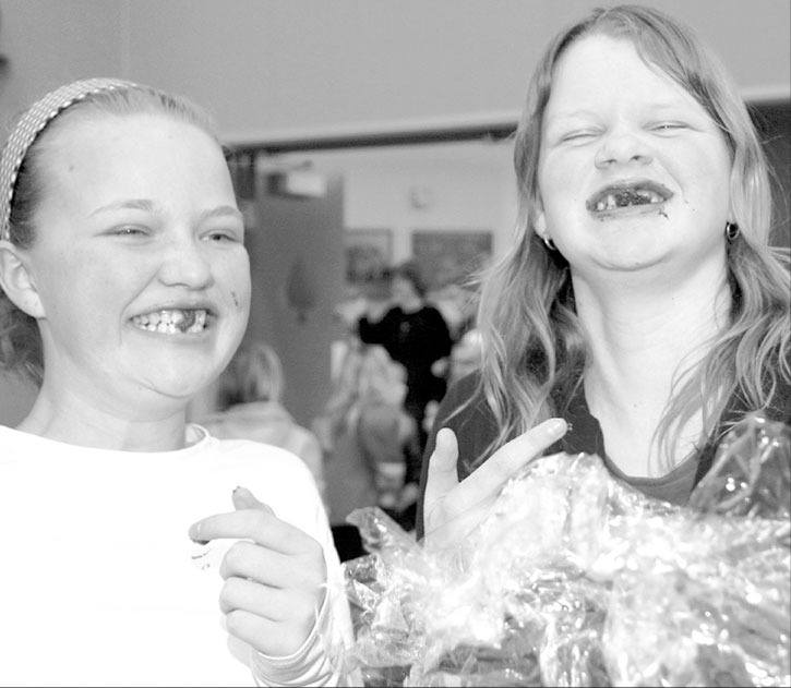 2007 — Grade 7 students Kate Godlien and Erin Hillary dig into their Cake-Walk prize during J.A. Laird’s Winter Carnival.