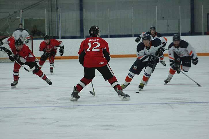 A Rockies player has his eye on the puck in the game against the Chase Heat at the Eddie Mountain Memorial Arena on November 14th.