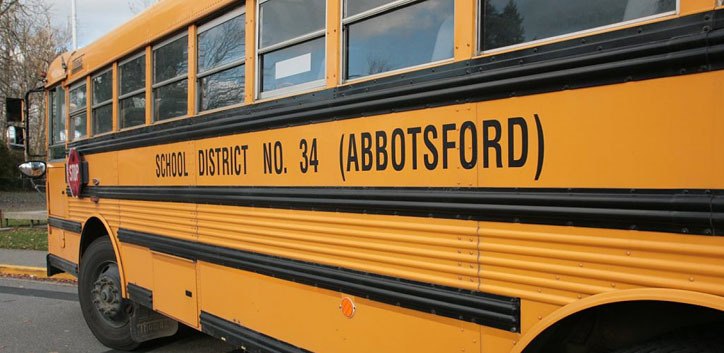 School buses use a hinged stop sign as well as flashing amber and red lights to warn drivers to stop when students are getting on and off.