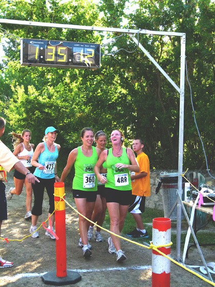 Runners remark at the times crossing the finish line during Loop the Lake.