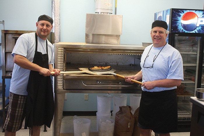 Vernon Victoor (left) and John Cain show off their new pizza oven at the Fairmont Pizza and Ice Cream Parlour in Fairmont Hot Springs.