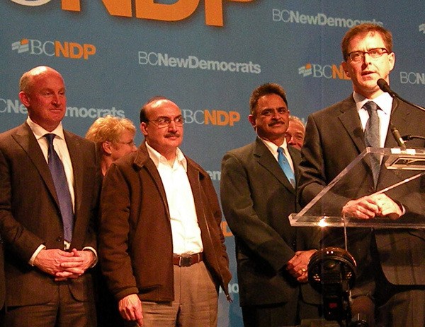 NDP leadership runner-up Mike Farnworth (left) and other MLAs take the stage with Vancouver-Kingsway MLA Adrian Dix for his victory speech in Vancouver Sunday evening.
