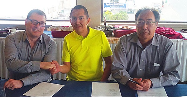 Steelhead LNG CEO Nigel Kuzemko (left) signs preliminary agreement for LNG project with Huu-ay-aht hereditary chief Derek Peters and chief councillor Jeff Cook.