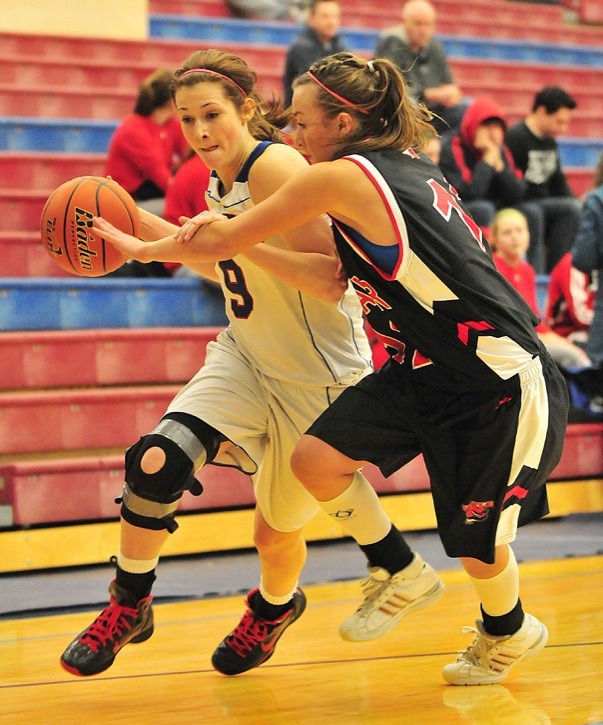 Brookswood Bobcats' Sydney Schepikoff fends off Breanne Feere of the Mt. Baker Wild during the 2011 B.C.high school AAA senior girls basketball championships at Capilano University. The tournament is moving to the Langley Events Centre beginning in March 2013.