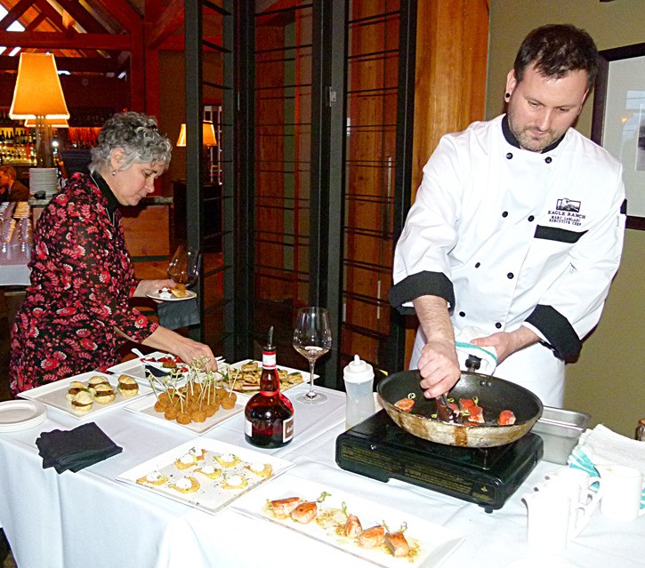 Eagle Ranch Golf Resort chef Marc LeBlanc (right) cooks up one of the many hors d'oeuvres dishes available at Eagle Ranch's first wine tasting event.