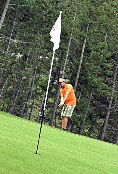 A golfer at the Lake Windermere and District Lions Club Charity Golf Tournament takes a swing on the green.