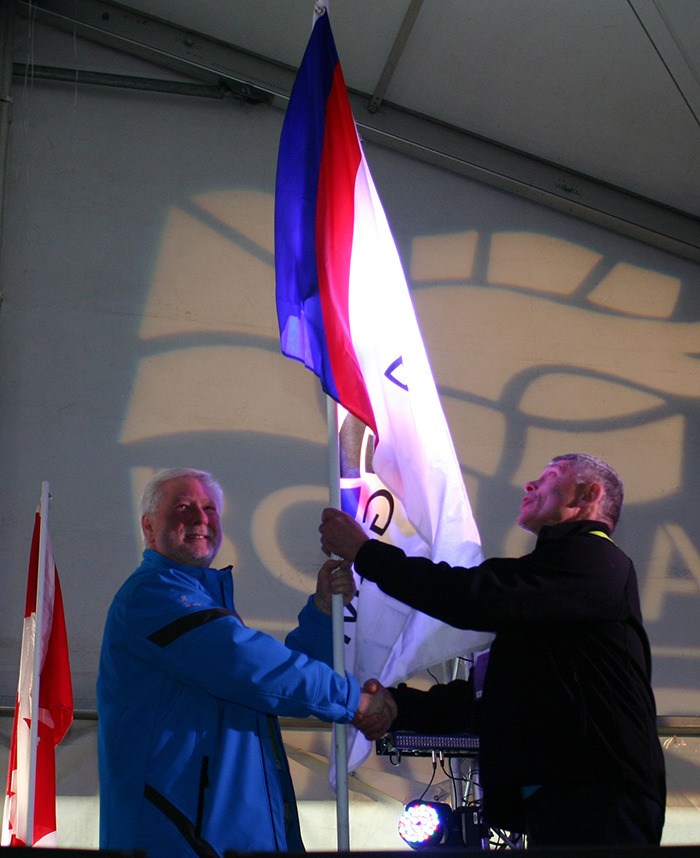 Mission B.C. Winter Games president Brian Antonson (left) passes the B.C. Games flag to Nanaimo Summer Games president Jeff Lott whose community will be hosting the B.C. Summer Games later this year.
