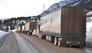 Trucks and other vehicles were lined up for a number of hours after three vehicles collided just north of Brisco. Three people lost their lives in the accident.  Darryl Crane/echo photo