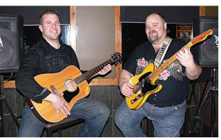 Justin Atterbury (left) and Marty Beingessner (right) get ready to jam in the setup area at Rocky River Grill. Musicians interested in playing on Wednesday's Jam Night should bring their own instruments