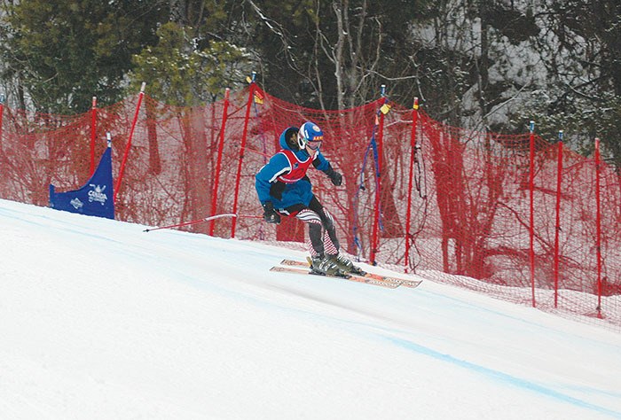 Skyler Wallinder of the Nakiska Alpine Ski Association catches some air off a lip during Sunday