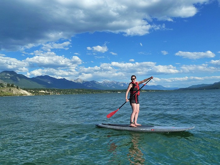 jenny hubrecht photo Karen Fraser demonstrates her newly acquired technique during her first stand-up paddleboard (SUP) experience on Lake Windermere. The lake offers a fantastic SUP opportunity early in the morning before motorized activity on the lake ramps up during the day.