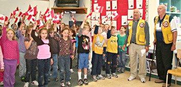 Eileen Madson students wave their flags to celebrate Canada Day early.