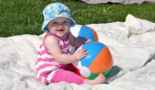 A child plays happily with some toys at the picnic.