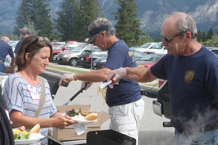 Rotarian Todd Fisher serves a Rocky Mountain School District 6 employee lunch during the by-annual congregation of Rocky Mountain S.D. 6 employees at David Thompson Secondary School on Wednesday August 29. Roughly 500 staff attended the meeting