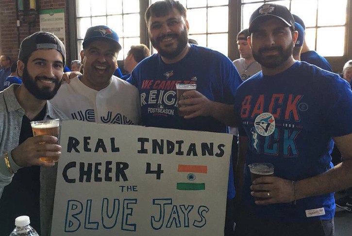 Daniel Bains (left) and his friends had this sign taken away as they entered a recent Toronto Blue Jays playoff game. Bains said they were told it would be 'too offensive' to Cleveland Indians fans