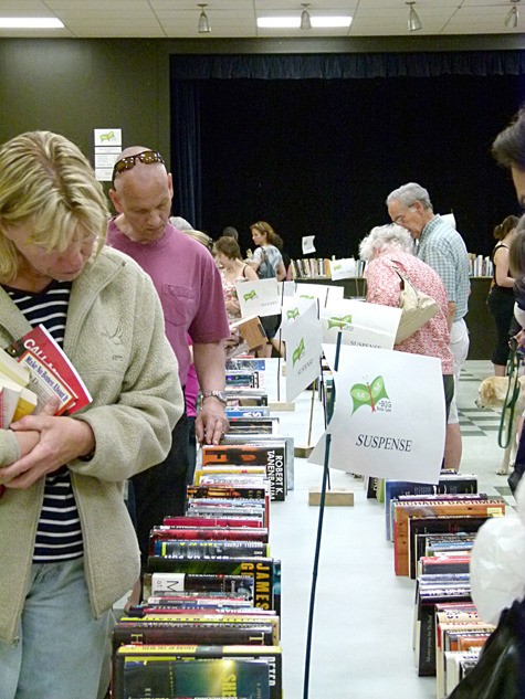 Book enthusiasts peruse the display at the BIG Book Sale on July 16.