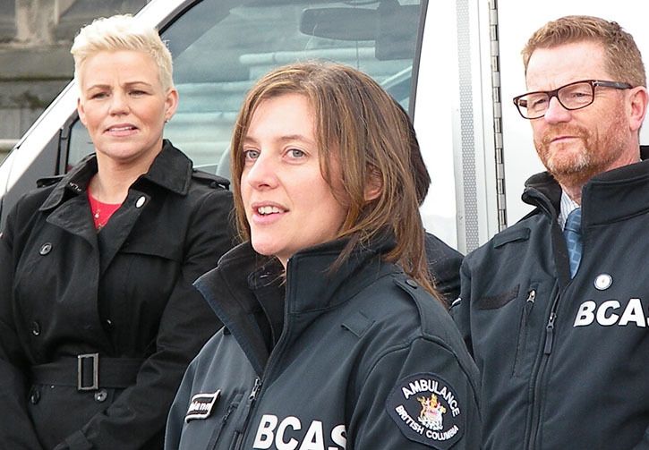 Paramedic union president Bronwyn Barter (left) and Health MInister Terry Lake listen to Tofino paramedic Rhiannon Davis describe her first six months making house calls under a new B.C. program.