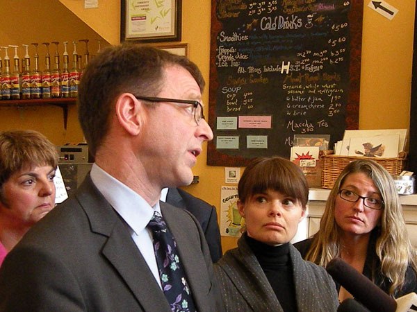 NDP leader Adrian Dix is flanked by MLA Carole James