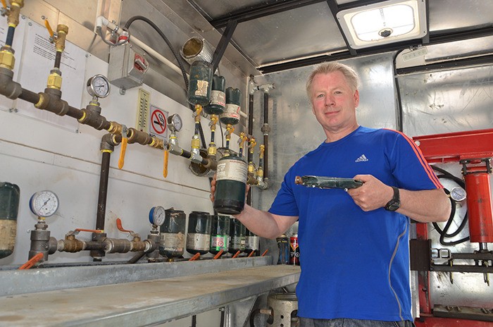 Jim Sands demonstrates the results of his homebuilt propane bottle recycling machine at Redstreak Campground on Friday