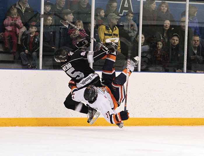 Columbia Valley Rockies forward Ryan Henderson collides mid-air with Fernie Ghostriders defenceman Patrick Webb during a hard fought 6 - 3 loss to the Ghostriders on Saturday