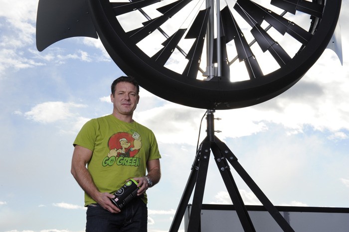 Kicking Horse Coffee president Leo Johnson stands next to one of the ten new wind turbines recently installed on the roof of the factory. He said they will begin producing power over the next couple of weeks.