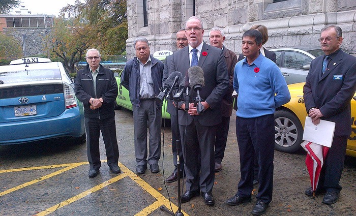 Flanked by taxi drivers and managers