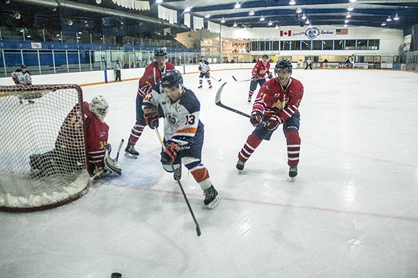 Rockies player Doan Smith takes the puck behind the net against the Golden Rockets on Sunday