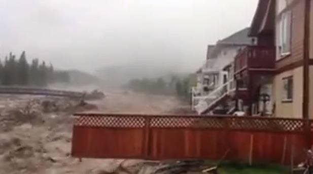 Flooding pounds through a neighbourhood of Canmore