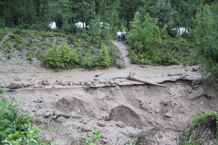 Stranded campers in the Spruce Grove RV Park & Campground wait for crews to build a temporary access road on Sunday (July 15) after a massive debris torrent washed out the bridge to the campground.