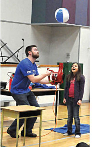 Science became very interactive as members of the Science World Road Team came to schools throughout the East Kootenay. Stephan Adamus (pictured above left) blasts off a pop bottle rocket with students at Eileen Madson Primary School while Kyle Bottom used a leaf blower to keep a beach ball in the air at Edgewater Elementary.   Darryl Crane/echo photo