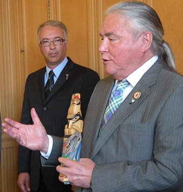 Aboriginal Relations Minister John Rustad listens as Bruce Parisian of Victoria Native Friendship Centre explains program of art works commissioned from a local people Monday.