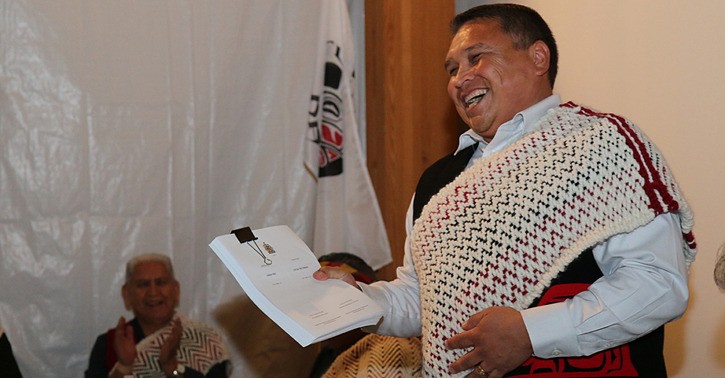 Tla'amin Chief Clint Williams holds a copy of his community's treaty at a ceremony in Powell River.
