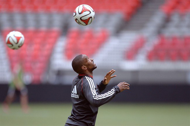 Toronto FC striker Jermain Defoe heads a ball at practice in Vancouver on Tuesday