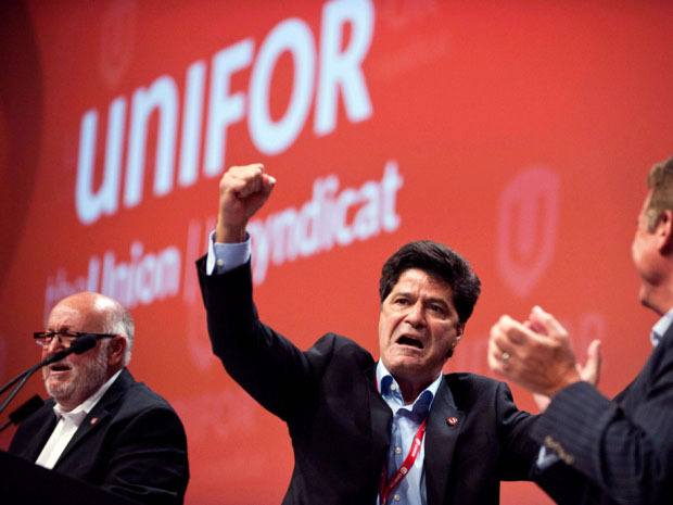 Unifor president Jerry Dias (centre) and Ontario Federation of Labour president Sid Ryan (left) have vowed an attack ad blitz on the Conservatives