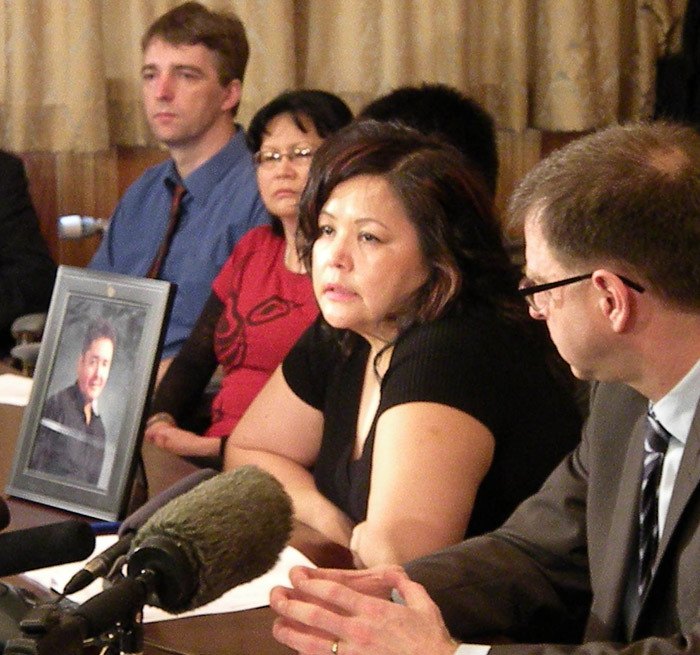 Injured mill worker Dirk Weissbach and his wife Kathleen (left) and NDP leader Adrian Dix (right) listen as Maureen Luggi speaks to reporters about the death of her husband Robert at Babine Forest Products sawmill in Burns Lake in 2012.